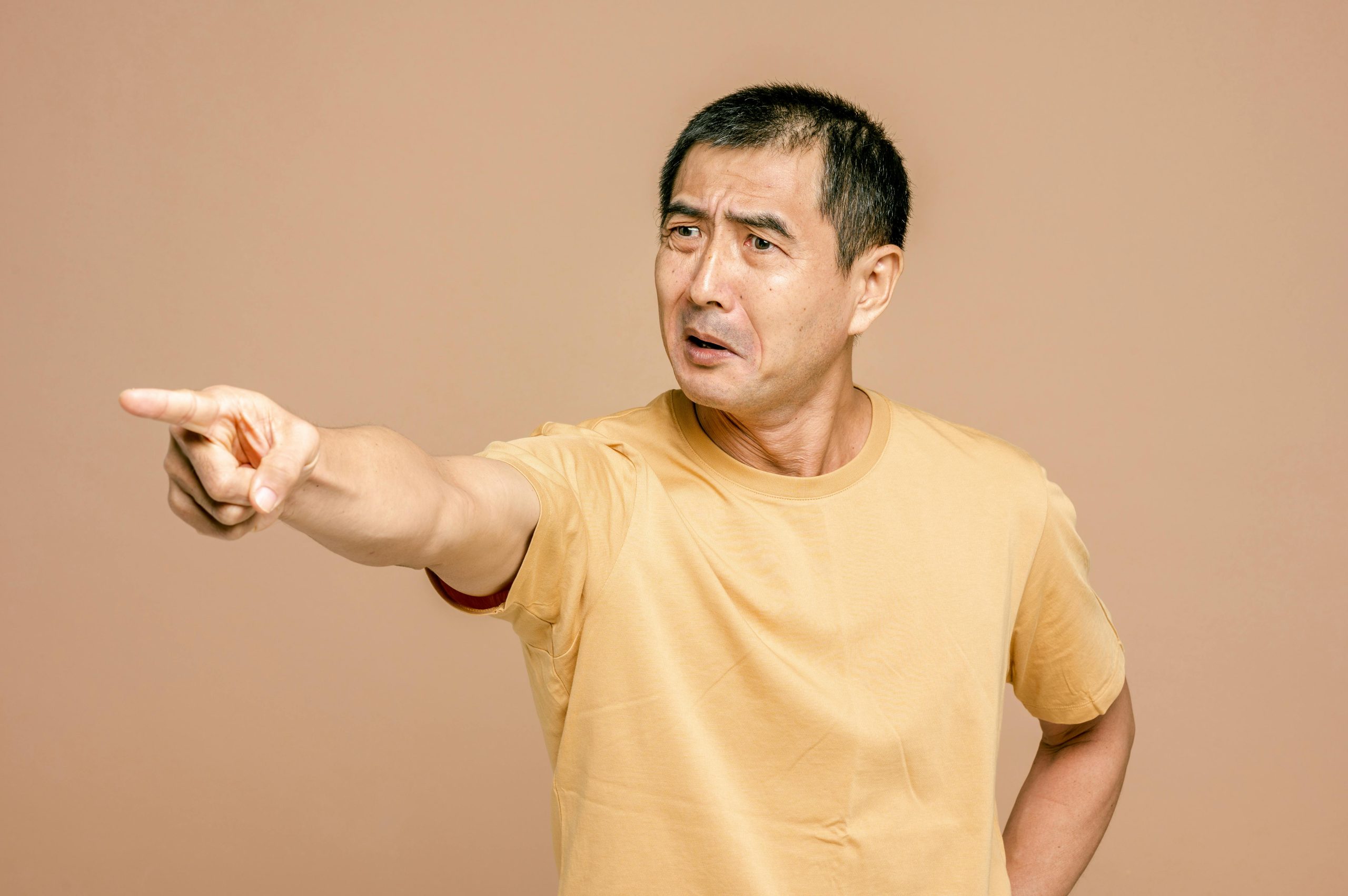 Man in Yellow Crew Neck T-shirt Pointing a Finger